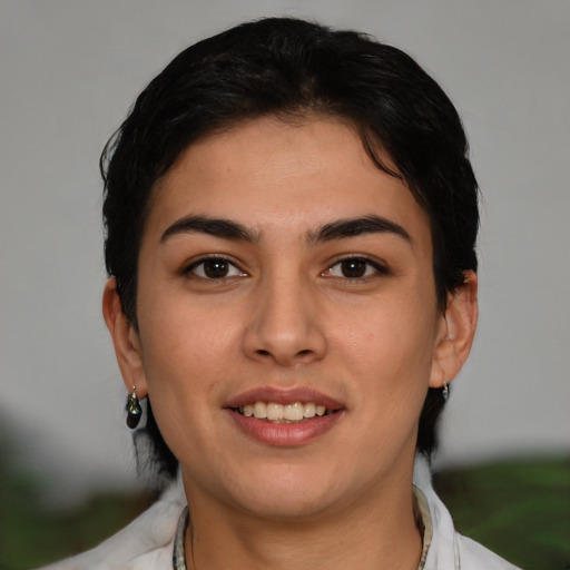 Joyful latino young-adult female with short  brown hair and brown eyes