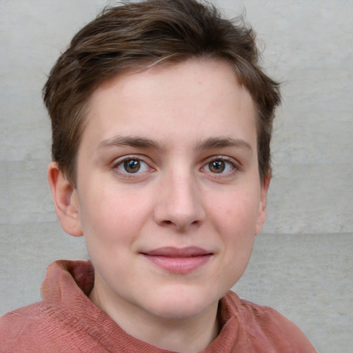 Joyful white young-adult female with short  brown hair and blue eyes