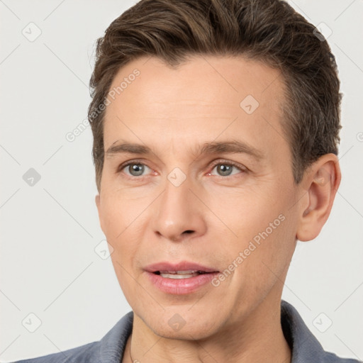 Joyful white adult male with short  brown hair and brown eyes