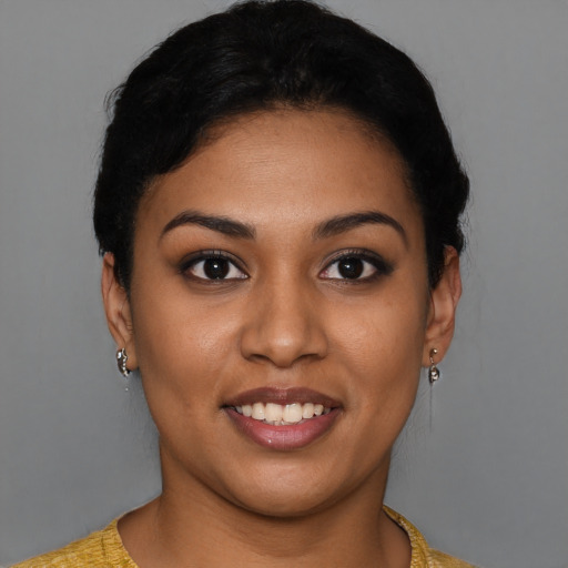 Joyful latino young-adult female with short  black hair and brown eyes