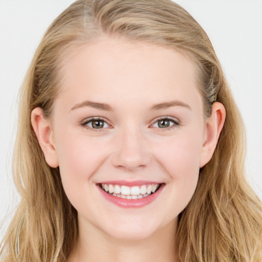 Joyful white young-adult female with long  brown hair and blue eyes