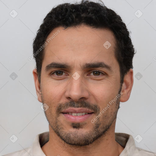 Joyful white young-adult male with short  black hair and brown eyes