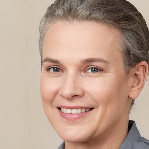 Joyful white adult female with short  brown hair and brown eyes