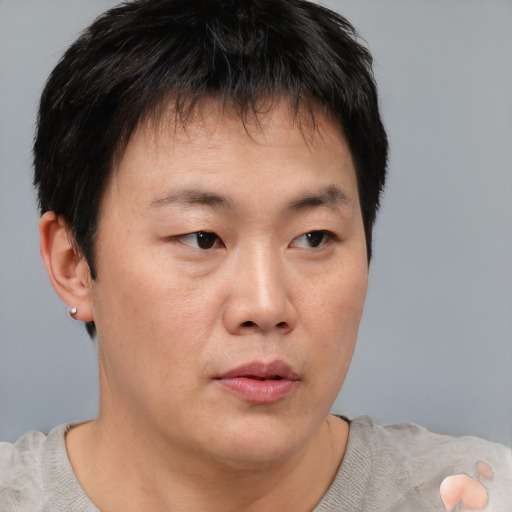 Neutral asian young-adult male with short  brown hair and brown eyes