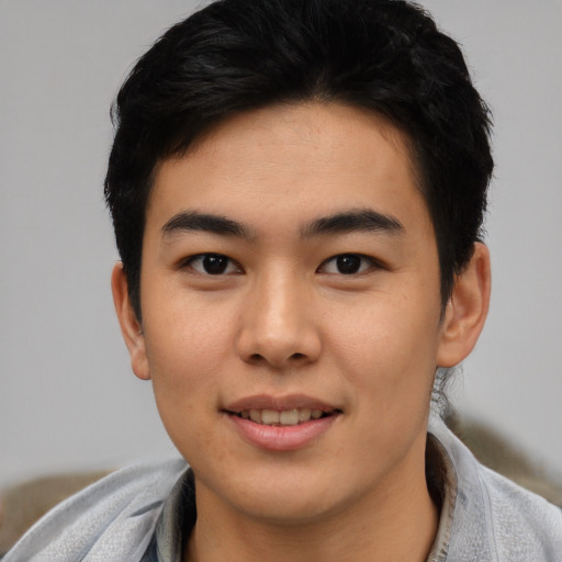 Joyful asian young-adult male with short  black hair and brown eyes