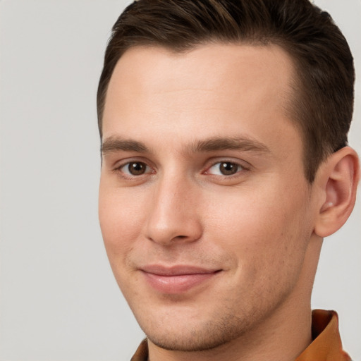 Joyful white young-adult male with short  brown hair and brown eyes