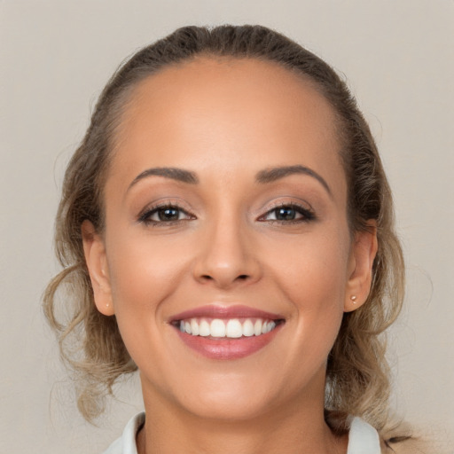 Joyful white young-adult female with long  brown hair and brown eyes