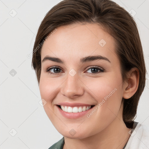 Joyful white young-adult female with medium  brown hair and grey eyes