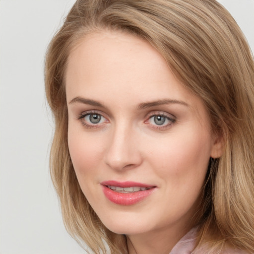 Joyful white young-adult female with long  brown hair and blue eyes