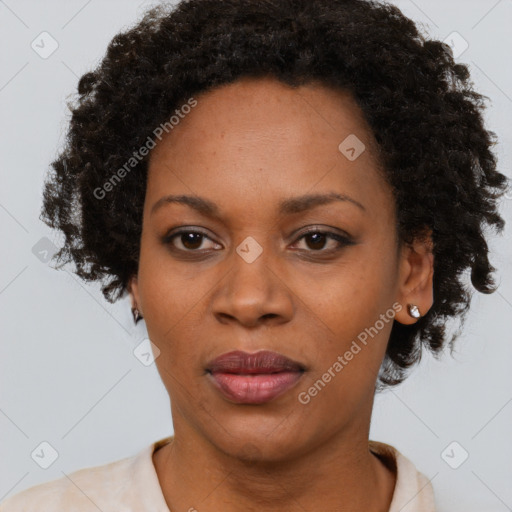 Joyful black adult female with short  brown hair and brown eyes