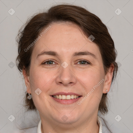 Joyful white adult female with medium  brown hair and grey eyes