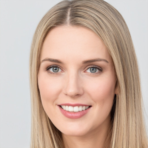 Joyful white young-adult female with long  brown hair and green eyes