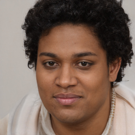 Joyful black young-adult female with short  brown hair and brown eyes