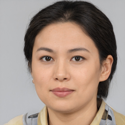 Joyful asian young-adult female with medium  brown hair and brown eyes