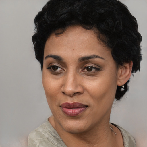 Joyful latino young-adult female with short  black hair and brown eyes