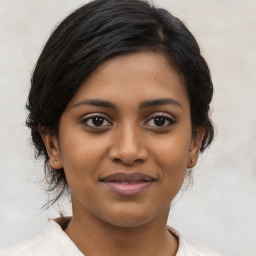 Joyful black young-adult female with medium  brown hair and brown eyes