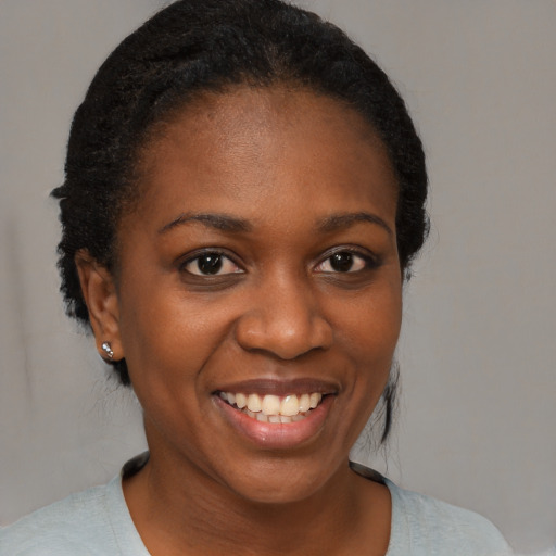 Joyful black young-adult female with medium  black hair and brown eyes