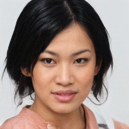 Joyful asian young-adult female with medium  black hair and brown eyes