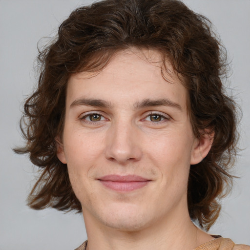 Joyful white young-adult male with medium  brown hair and brown eyes