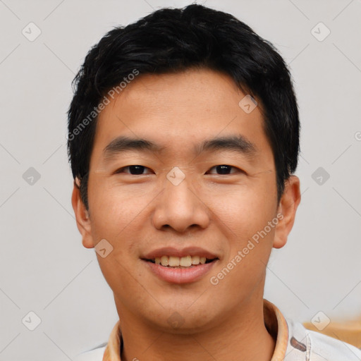 Joyful asian young-adult male with short  black hair and brown eyes