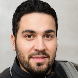 Joyful white young-adult male with short  black hair and brown eyes