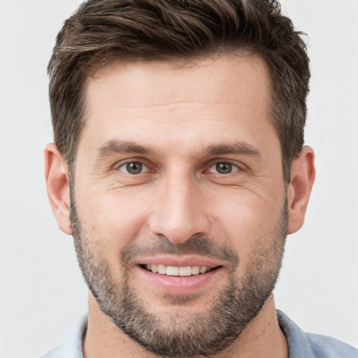 Joyful white young-adult male with short  brown hair and brown eyes