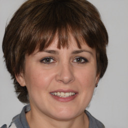 Joyful white adult female with medium  brown hair and grey eyes