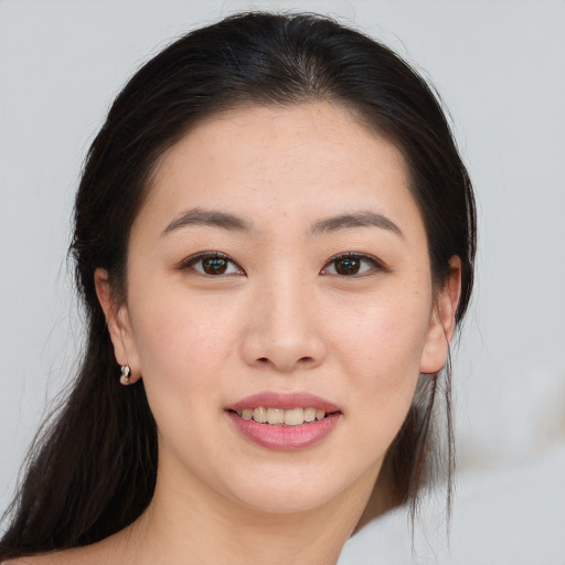 Joyful asian young-adult female with long  brown hair and brown eyes