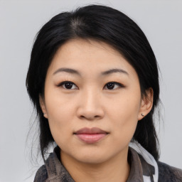 Joyful asian young-adult female with medium  black hair and brown eyes