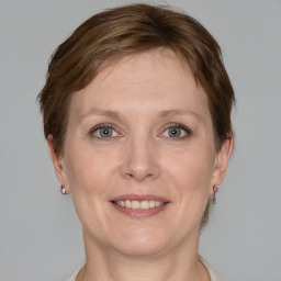 Joyful white adult female with short  brown hair and grey eyes