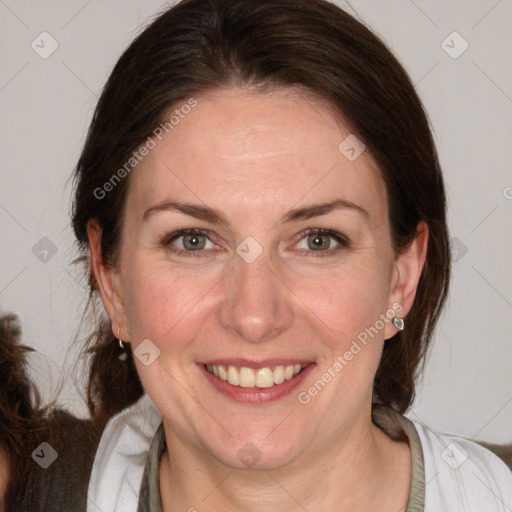 Joyful white adult female with medium  brown hair and blue eyes