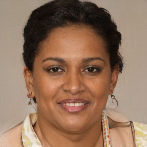 Joyful black adult female with short  brown hair and brown eyes