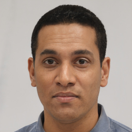 Neutral latino adult male with short  black hair and brown eyes