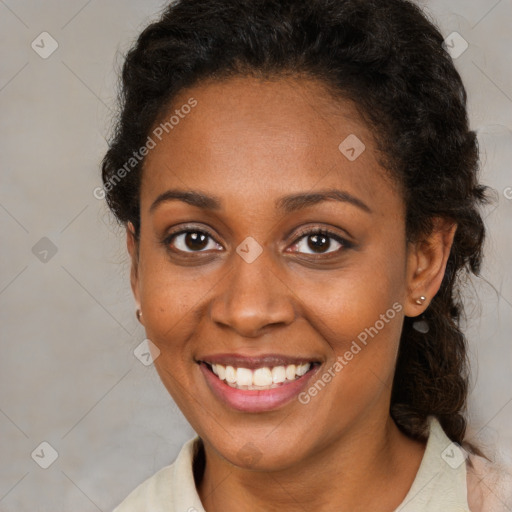 Joyful black young-adult female with medium  brown hair and brown eyes