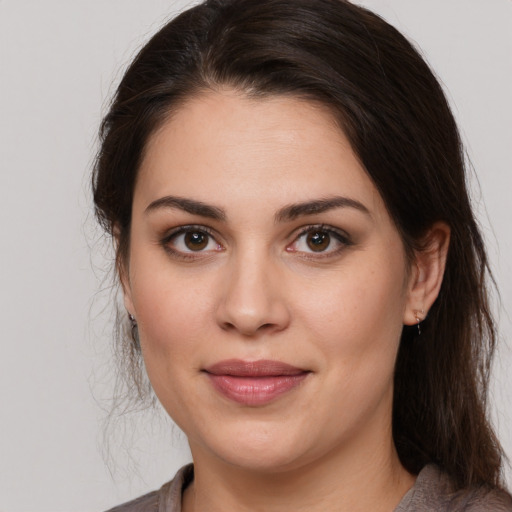 Joyful white young-adult female with medium  brown hair and brown eyes