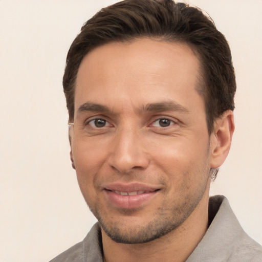 Joyful white young-adult male with short  brown hair and brown eyes