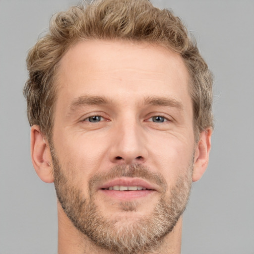 Joyful white adult male with short  brown hair and grey eyes