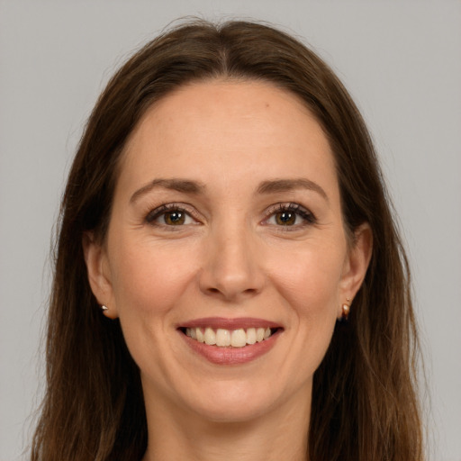 Joyful white young-adult female with long  brown hair and grey eyes