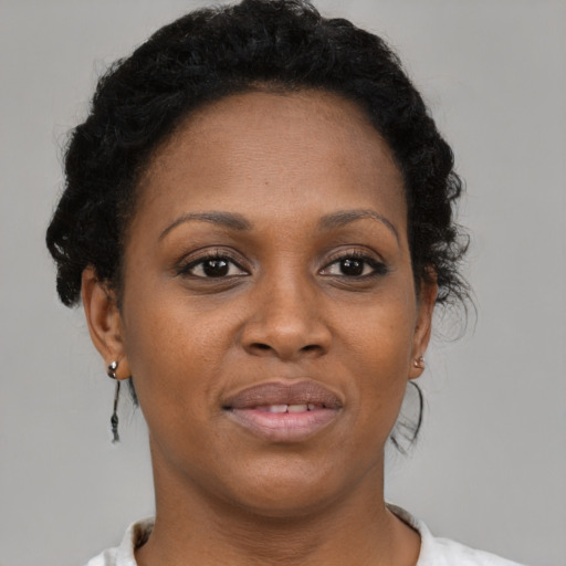 Joyful black adult female with short  brown hair and brown eyes