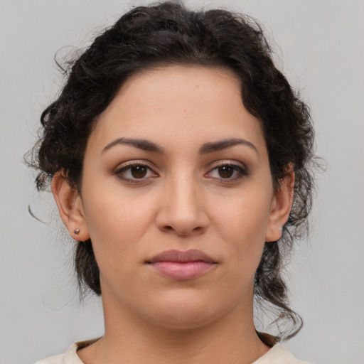 Joyful latino young-adult female with medium  brown hair and brown eyes