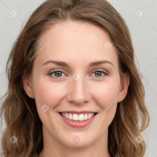 Joyful white young-adult female with long  brown hair and blue eyes