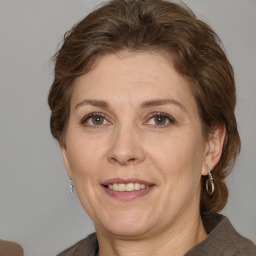 Joyful white adult female with medium  brown hair and grey eyes