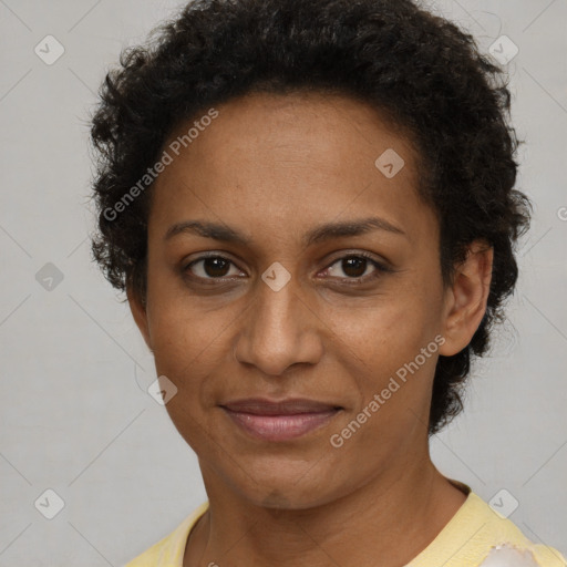 Joyful black adult female with short  brown hair and brown eyes