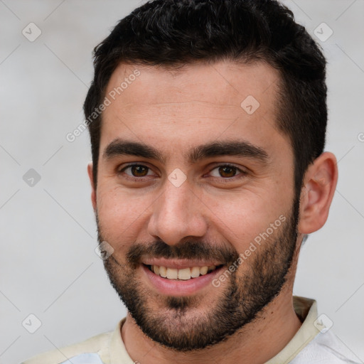 Joyful white young-adult male with short  brown hair and brown eyes