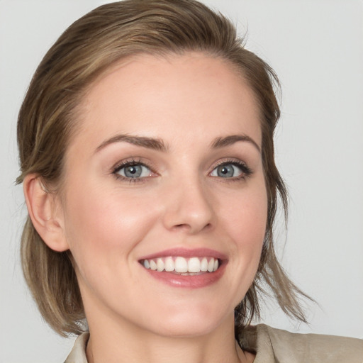 Joyful white young-adult female with medium  brown hair and blue eyes