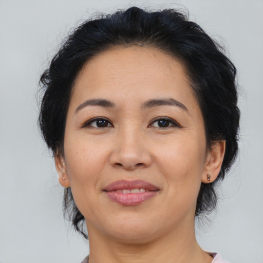 Joyful asian adult female with medium  brown hair and brown eyes