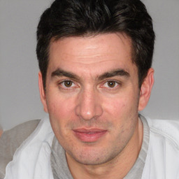 Joyful white adult male with short  brown hair and brown eyes