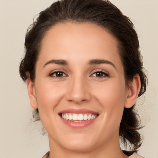 Joyful white young-adult female with medium  brown hair and brown eyes