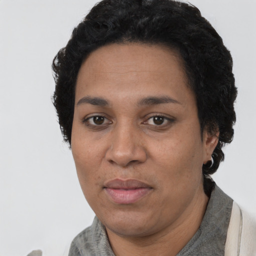 Joyful latino adult female with short  black hair and brown eyes