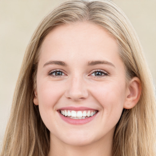 Joyful white young-adult female with long  brown hair and blue eyes